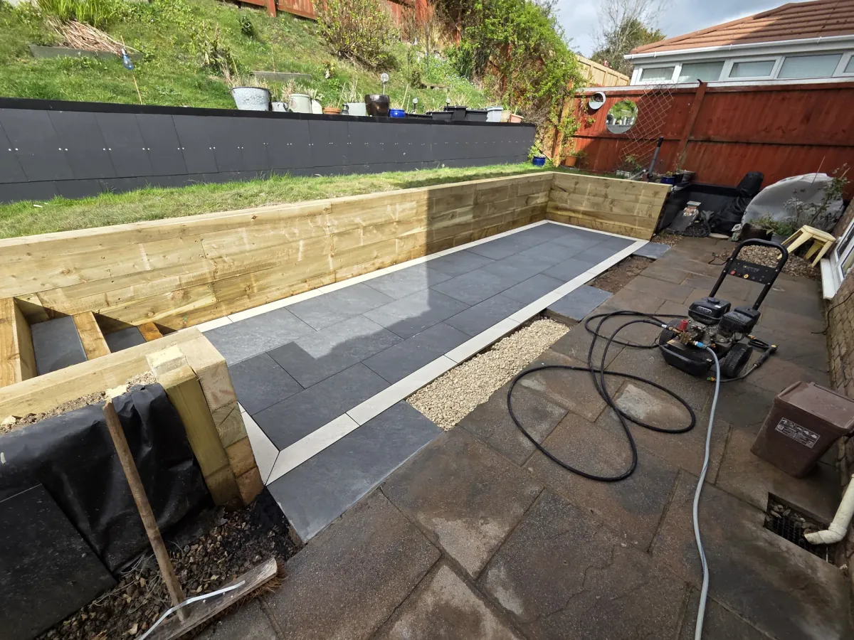 Completed tiered patio with Indian stone and sleeper beds in Porthcawl